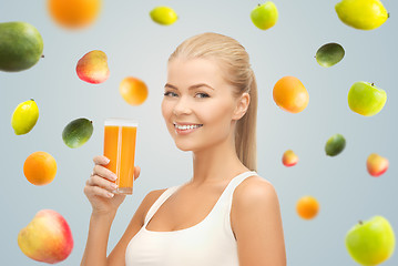 Image showing happy woman holding glass of orange juice