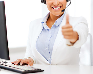 Image showing african female helpline operator showing thumbs up