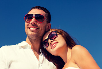 Image showing smiling couple over blue sky background