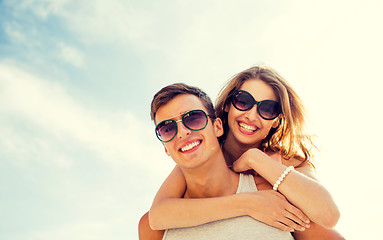 Image showing smiling couple having fun over sky background