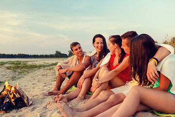 Image showing smiling friends in sunglasses on summer beach