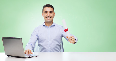 Image showing smiling man with diploma and laptop at table