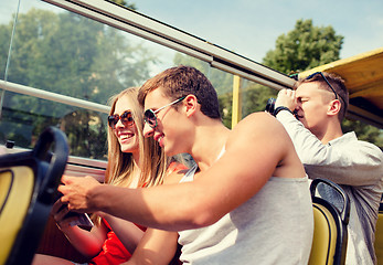 Image showing smiling couple with book traveling by tour bus