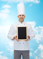 Image showing happy male chef cook holding blank menu board