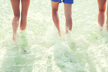 Image showing close up of human legs on summer beach