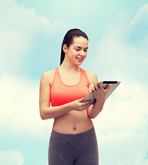 Image showing sporty woman with tablet pc computer