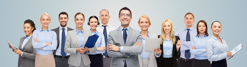 Image showing group of happy businesspeople over blue background