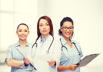 Image showing calm female doctor with clipboard