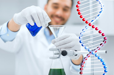 Image showing close up of scientist with test tubes and funnel