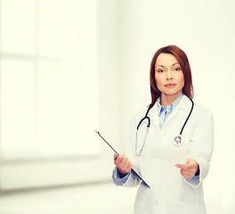 Image showing calm female doctor with clipboard