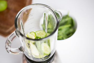 Image showing close up of blender jar and green vegetables