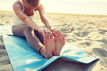 Image showing close up of woman making yoga exercises outdoors