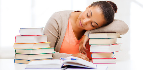 Image showing tired student with books and notes