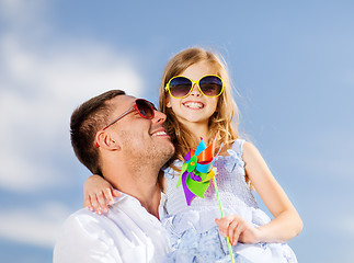 Image showing happy father and child in sunglasses over blue sky