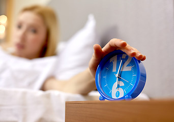 Image showing close up of hand on alarm clock in bedroom