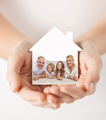 Image showing close up of hands holding house shape with family