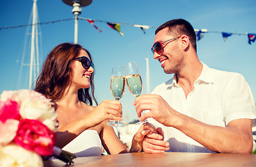 Image showing smiling couple drinking champagne at cafe