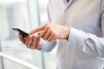 Image showing close up of man hands with smartphone at office