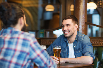 Image showing happy male friends drinking beer at bar or pub