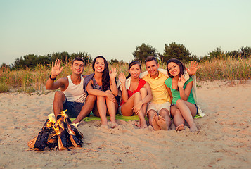 Image showing smiling friends in sunglasses on summer beach