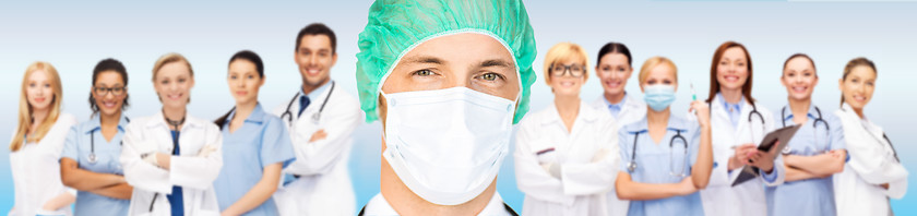 Image showing surgeon in medical cap and mask over team