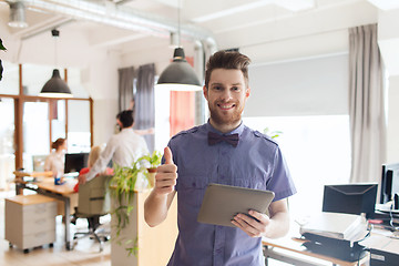 Image showing happy creative male office worker with tablet pc