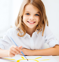 Image showing little girl painting at school