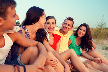 Image showing smiling friends in sunglasses on summer beach