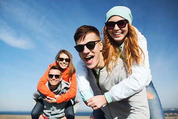 Image showing happy teenage friends having fun outdoors