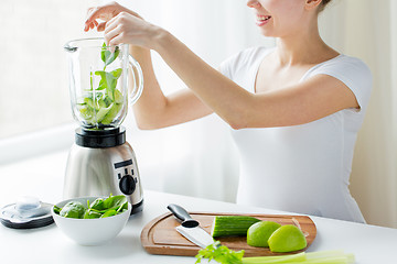 Image showing close up of woman with blender and vegetables