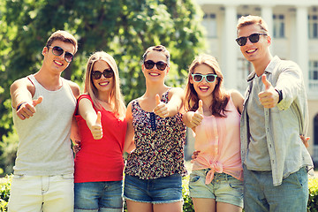 Image showing group of smiling friends showing thumbs up