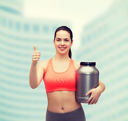 Image showing teenage girl with jar of protein showing thumbs up