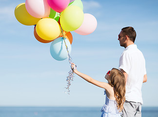 Image showing father and daughter with colorful balloons