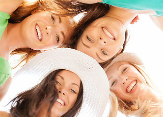 Image showing faces of girls looking down and smiling