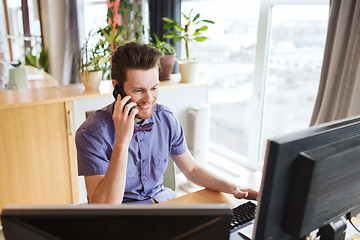 Image showing happy creative male worker calling on smarphone