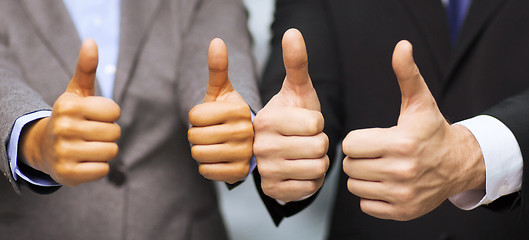 Image showing businessman and businesswoman showing thumbs up