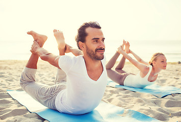 Image showing couple making yoga exercises outdoors