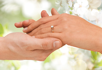 Image showing close up of man and woman hands with wedding ring