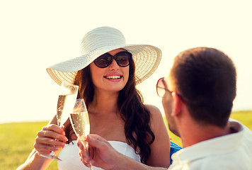 Image showing smiling couple drinking champagne on picnic