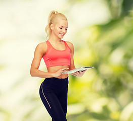 Image showing smiling sporty woman with tablet pc computer