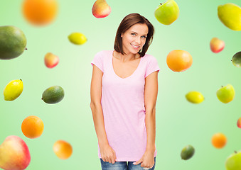 Image showing happy woman in blank white t-shirt over fruits