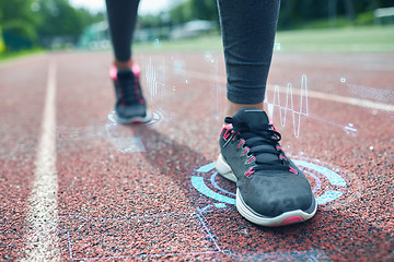 Image showing close up of woman feet running on track