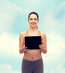 Image showing sporty woman with tablet pc blank screen