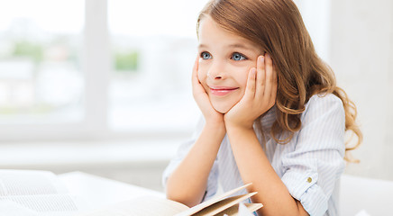 Image showing student girl writing in notebook at school