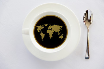 Image showing world map in cup of black coffee with spoon