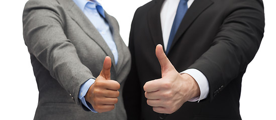 Image showing businessman and businesswoman showing thumbs up