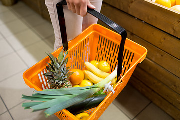 Image showing close up of woman with food basket in market