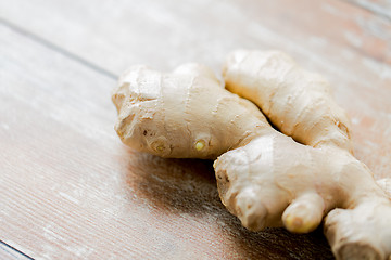 Image showing close up of ginger root on wooden table