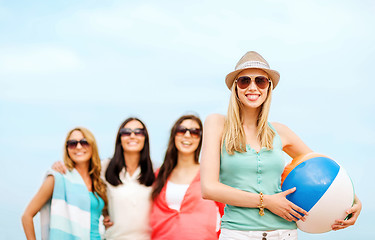 Image showing girl with ball and friends on the beach