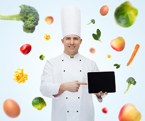 Image showing happy male chef cook showing with tablet pc